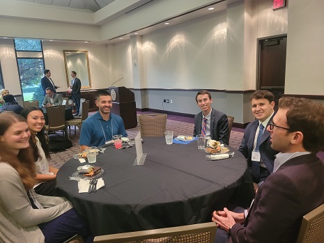 Another group of alumni and current students chat during the event