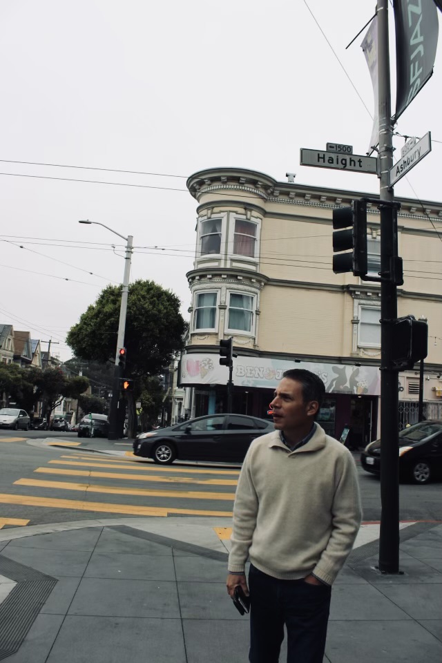 Dr. Hidalgo standing on the corner of Haight St and Ashbury St in San Francisco