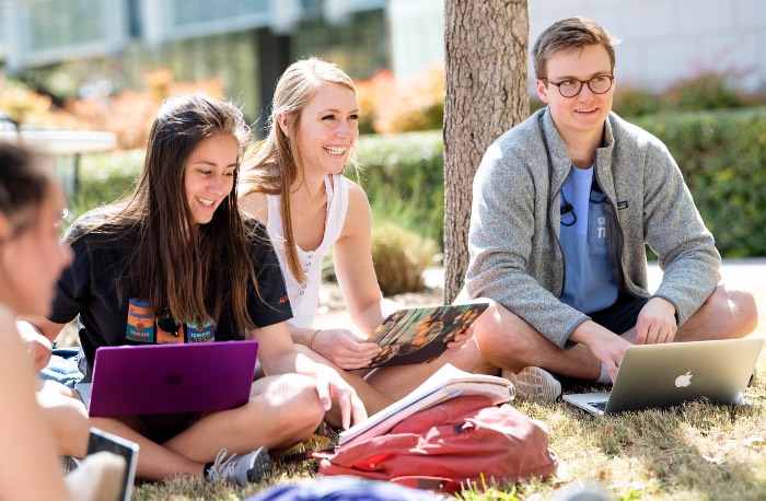 Students smile as they work outside