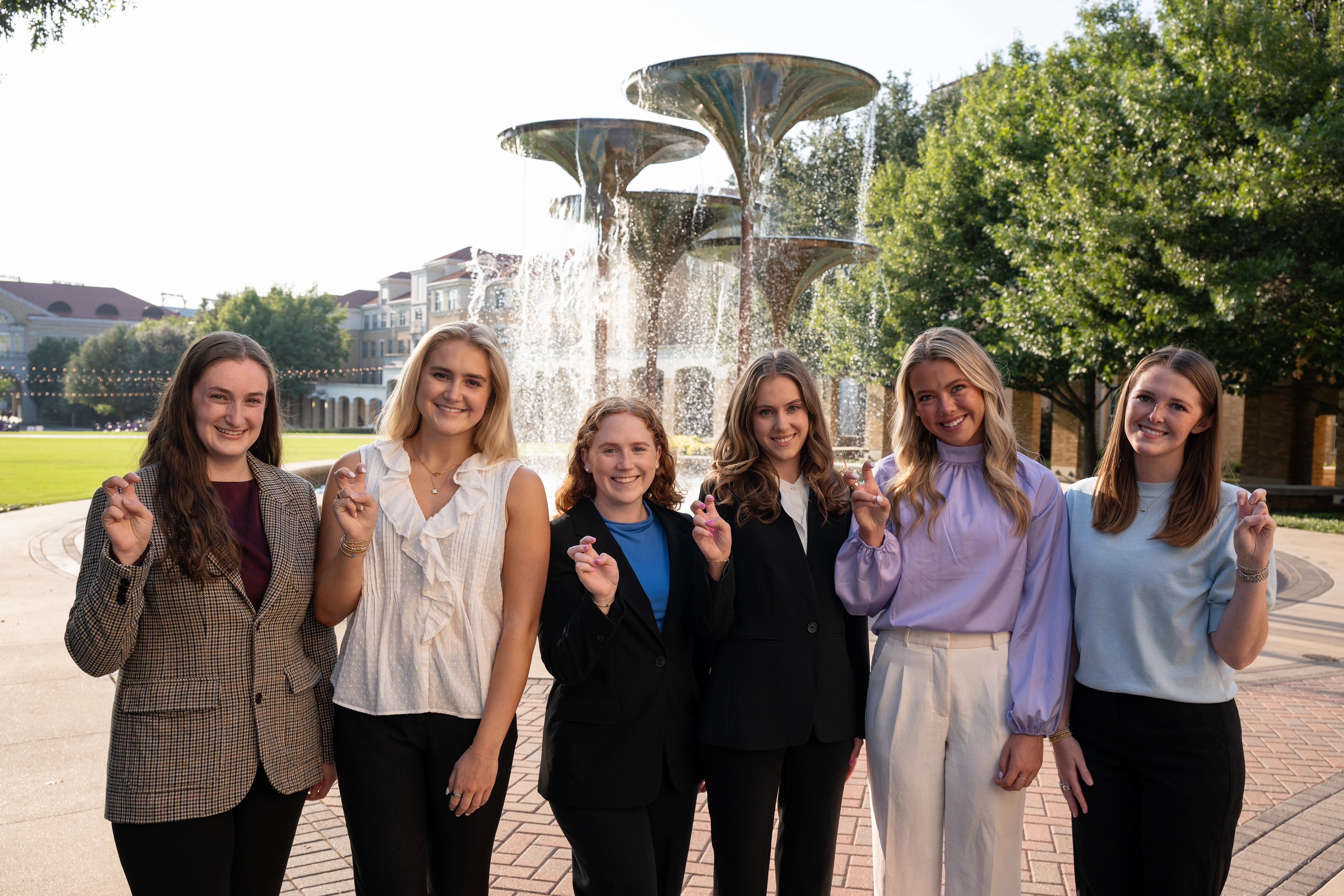 AddRan Ambassadors Leadership Academy student leadership pose for a picture with the Go Frogs hand sign.