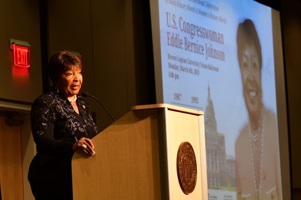 Person standing at podium giving a speech.